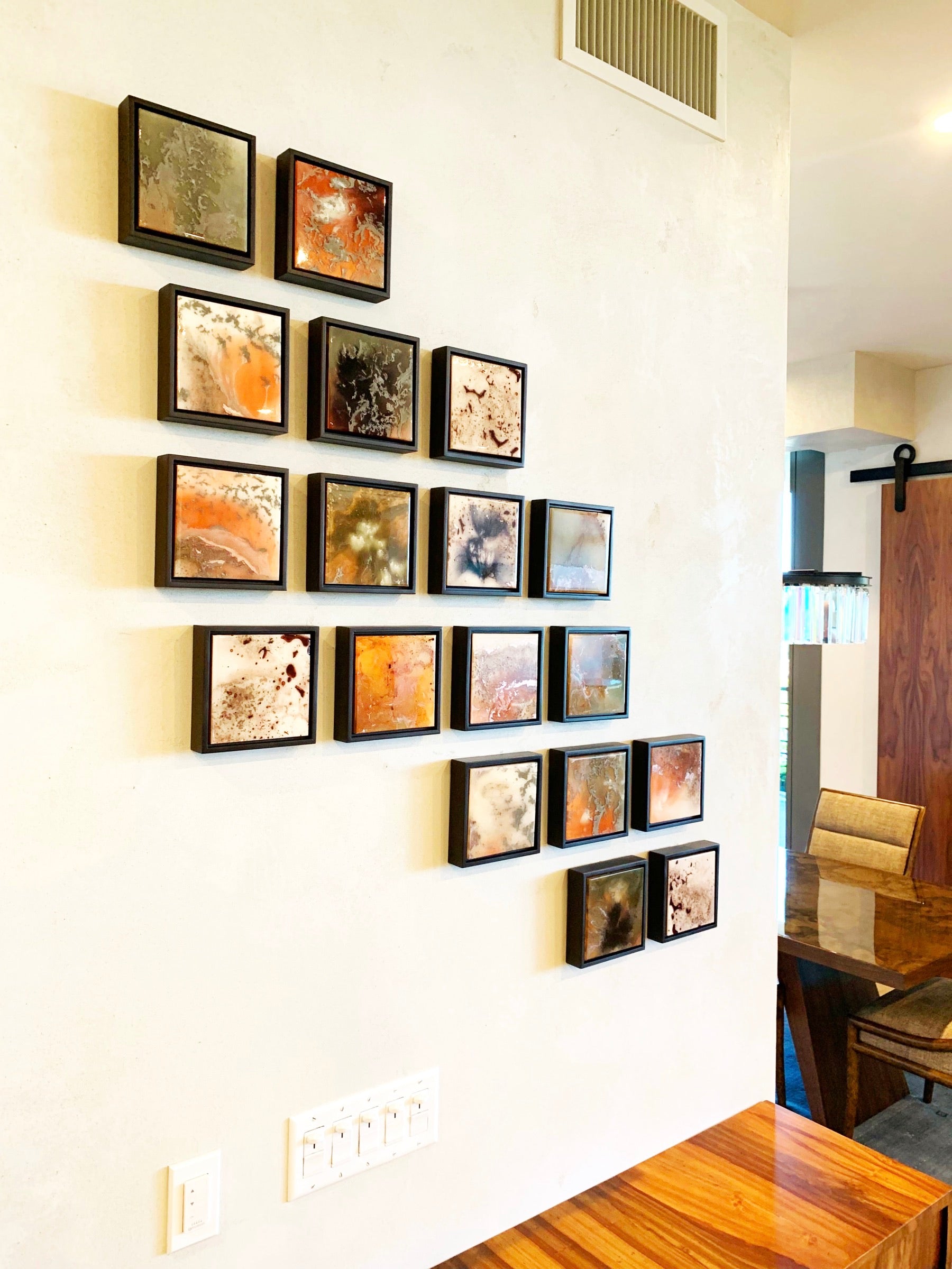 A gallery wall of small 6-inch House of Moen originals cascading across the wall